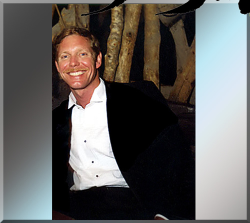 Photo of Jerry Michelsen relaxing in an open shirted tuxedo at a table in la cabana de pancho villa in Puerto Vallarta Mexico in 1983